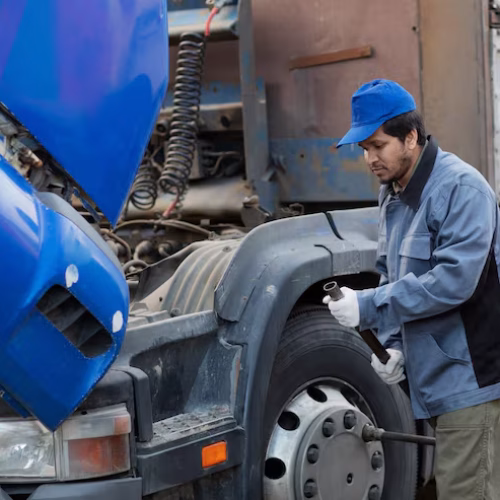 side-view-mechanic-checking-truck_23-2149426542